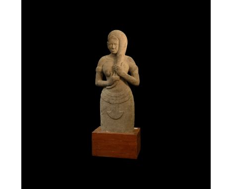 10th-12th century AD. A statuette of oolitic laterite(?) depicting a standing female (Devata) in pleated skirt and diadem wit