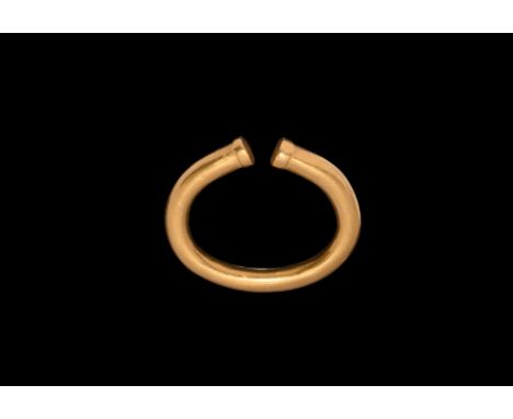 2nd-1st millennium BC. A gold penannular ring with clubbed terminals.   18 grams, 32mm (1 1/4"). Property of an English gentl