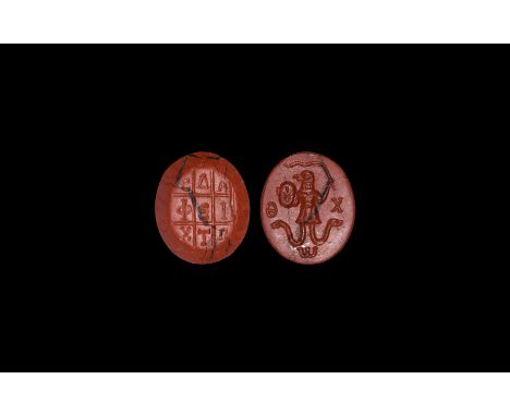 4th-7th century AD. A red jasper gemstone with two carved faces: intaglio Anguiped (Abrasax) with serpent-legs, shield and wh