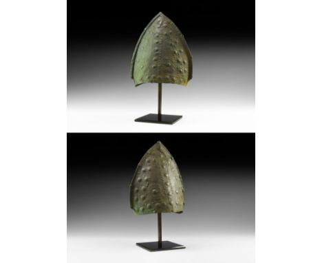 12th-7th century BC. A bronze helmet of the Urnfield Culture formed as two triangular panels with an applied riveted seam to 