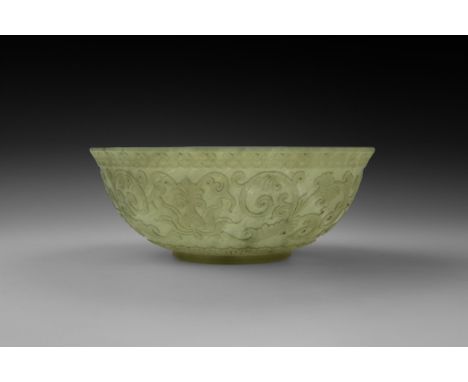 17th-18th century AD. A carved translucent jade bowl with basal ring and everted rim, running swags below the rim, chrysanthe