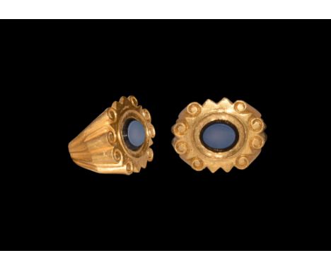 3rd century AD. A gold ring comprising a D-section hoop with angled shoulders, columnar detailing terminating in scrolled end