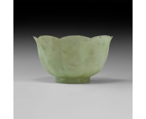 17th-18th century AD. A carved translucent jade floral cup with basal ring, bowl formed as eight petals with everted rim.   2