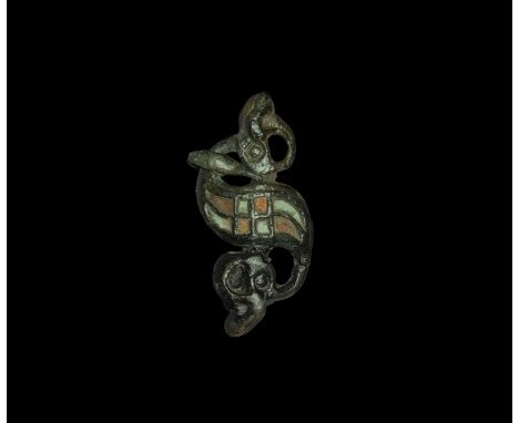 2nd century AD. A bronze dragonesque brooch with S-shaped body, two beast-head finials, median grid of enamelled cells, secti