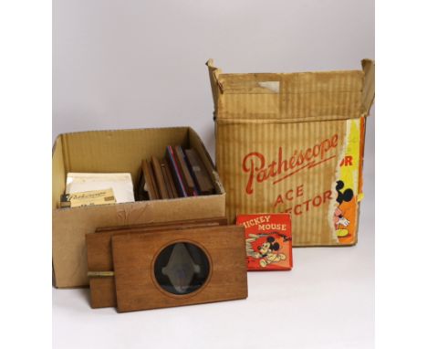 A collection of magic lantern slides, including some painted examples and some in frames, together with a 9.5mm Pathescope Ac