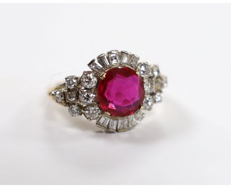 A yellow metal, singe stone round cut synthetic ruby and diamond set circular cluster dress ring, with diamond set shoulders,