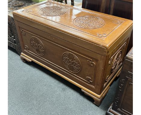 An Asian lacquered carved camphorwood trunk, length 101cm, depth 49cm, height 61cm