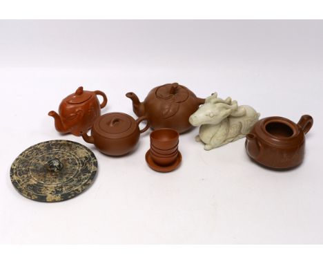 Eleven Chinese items including four Yixing pottery teapots, a stone disc, a jade horse and five miniature bowls, tallest teap