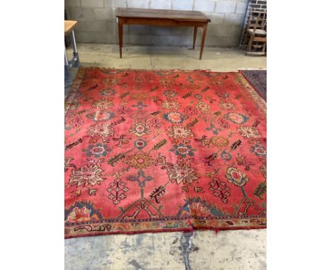 An Afghan woven wool red ground carpet, 306 x 268cm