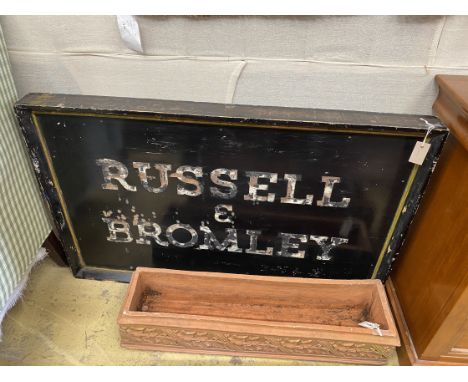 A vintage rectangular painted 'Russell &amp; Bromley' advertising sign, length 123cm, height 78cm