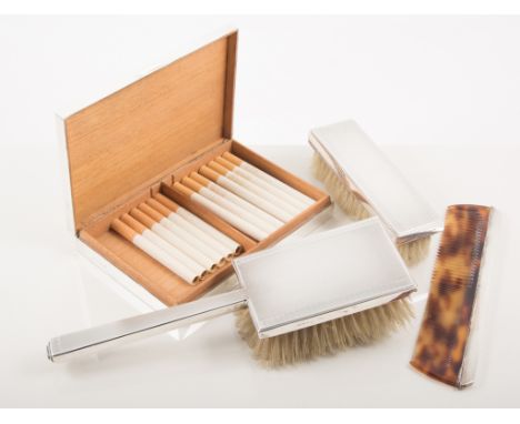 A silver Art Deco style four piece dressing table set, comprising hand mirror, hair brush, comb and clothes brush, engine tur