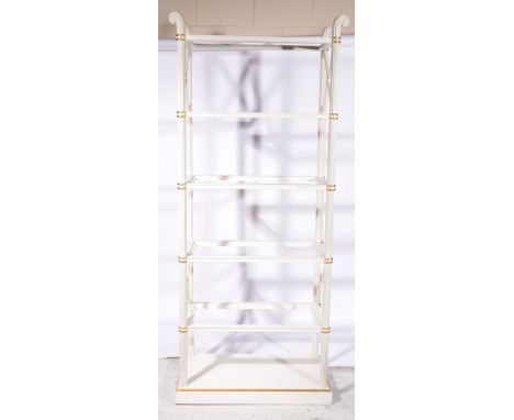 A painted and gilt six tier shelving unit, each shelf inset with rectangular glass plates on reeded uprights, on shaped plint