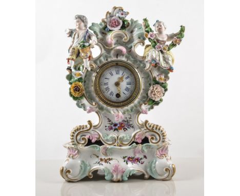 A Meissen style porcelain mantel clock, floral encrusted two figures with garlands of flowers, some damage, crossed swords ma