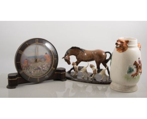 Heredities charm of creamware model, horse and hounds, mahogany effect plinth base, length overall 28cm; pottery hunting tank