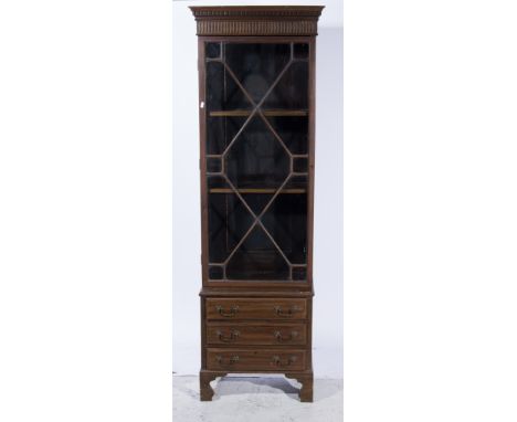 Slender bookcase, glazed and elongated door, enclosing two adjustable shelves above three short drawers, bracket feet, W62 x 