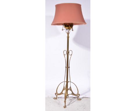 Art Nouveau style brass standard lamp, tripod base, adapted to electricity, with shade, 160cm as fitted.