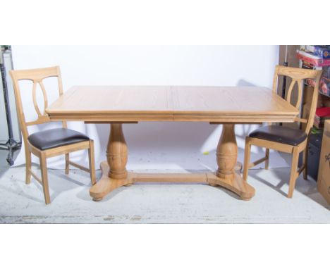 A modern light oak dining suite, comprising extending dining table, rectangular top, rounder corners, moulded edge, on twin b