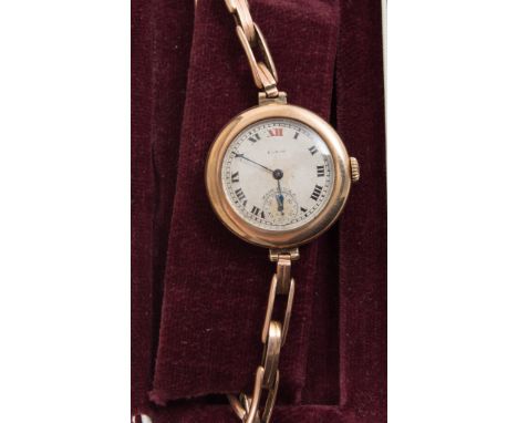 Three wristwatches, ladies Elgin with circular roman numeral dial in a gold coloured case with expanding bracelet, ladies Rot