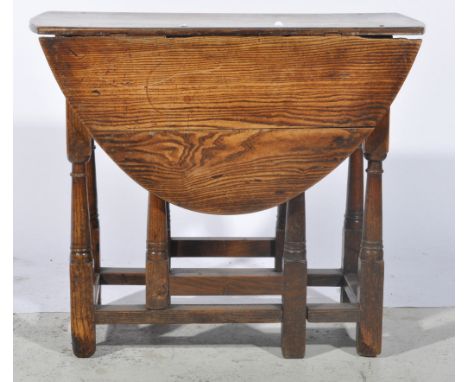 Georgian oak gate leg tea table, oval top above single freze drawer, on turned supports joined by stretchers, W74cm x H63cm.
