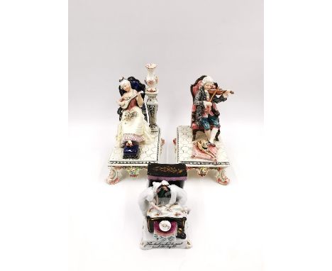 A Royal Dux porcelain figure group depicting an 18th century gentleman playing the violin with a dog at his feet, along with 