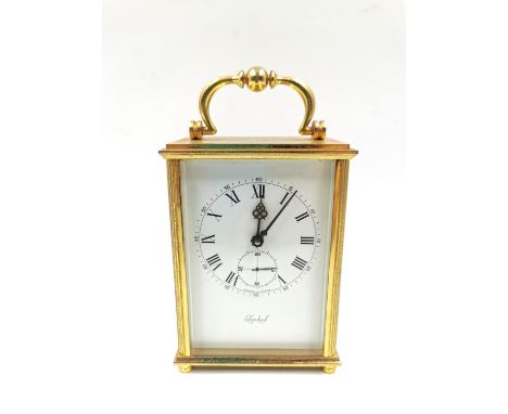 A Swiss made brass carriage clock by Imhof with 15 jewels. H.15cm incl of handle.