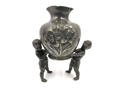 A French Art Nouveau Etaine Garanti pewter vase supported by two putti/cherubs with an indistinct hand painted inscription to