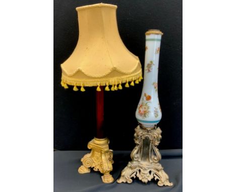A late Victorian hand painted milk glass lamp stand, silver metal baroque style stand, 62cm high; ruby glass lamp shade, on g