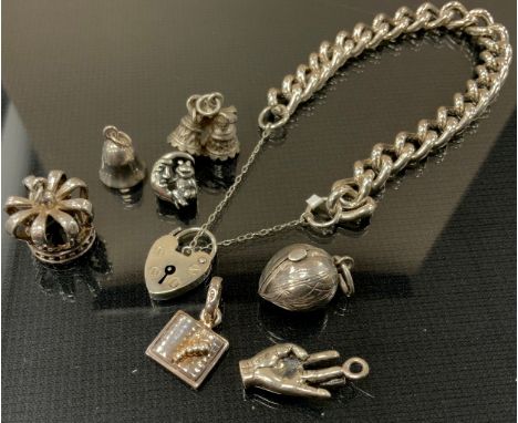 A 925 silver bracelet, padlock clasp,  seven loose charms, crown, Acorn, bells, hand etc 46g gross;  a Timex intelligent Quar