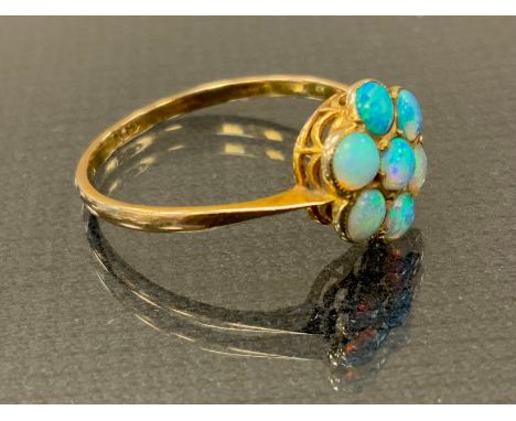 An opal cluster ring,  seven blue green cabochon opals, 9ct gold shank, size O, 1.2g gross 