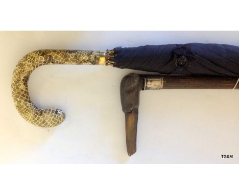 A carved horn greyhound walking stick with snake skin umbrella