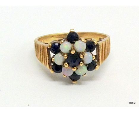 A 9ct Gold Opal and garnet cluster ring size 0