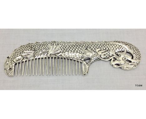 An Oriental white metal comb depicting dragons