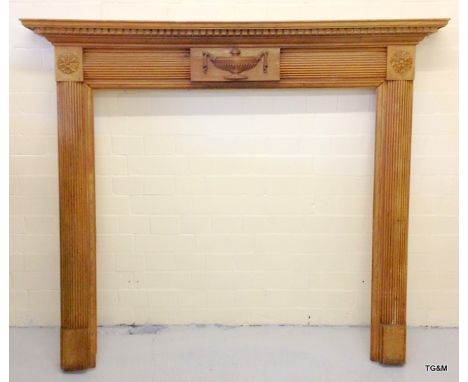 A large pine carved fire surround