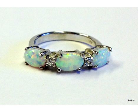 A silver opal and cz ring