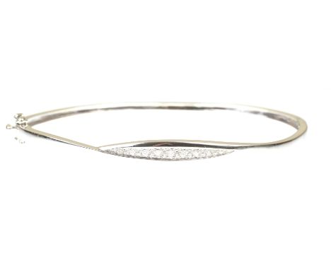 A diamond hinged bangleThe graduated round brilliant-cut diamonds set to a navette panel, to a plain 9k white gold bangle, wi
