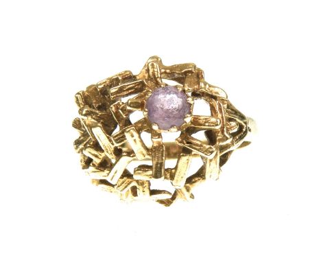 A 1970s amethyst ringOf abstract design, set with a circular shaped amethyst, shank stamped 9ct, ring size G