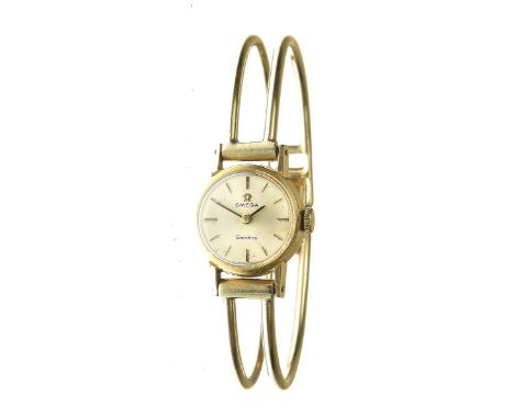 Omega: A ladies manual wind bracelet watchThe silvered dial, with applied gold baton hour markers, with black hands, to a cir