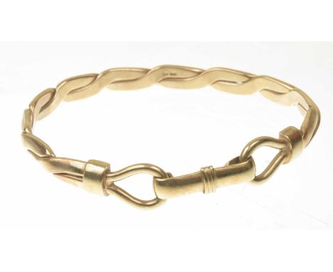 A 9k gold bangleThe plaited bangle, terminating at each end with loops and a push bar clasp, in 9k gold, length 7.6cm, weight