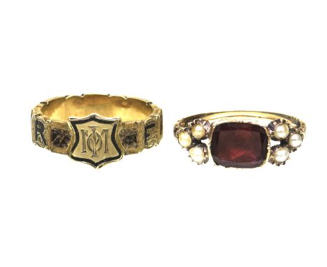A Victorian garnet and seed pearl mourning ringThe foiled back, flat-cut garnet, flanked by three seed pearl clusters, in pre
