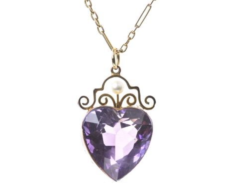 An amethyst and seed pearl pendantThe heart shape amethyst surmounted by a scroll frame work and a half pearl, to a fine figa