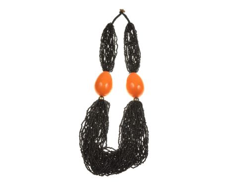 An amber style and multi strand bead necklaceThe strands of black beads, separated by two large tapered amber style beads, to