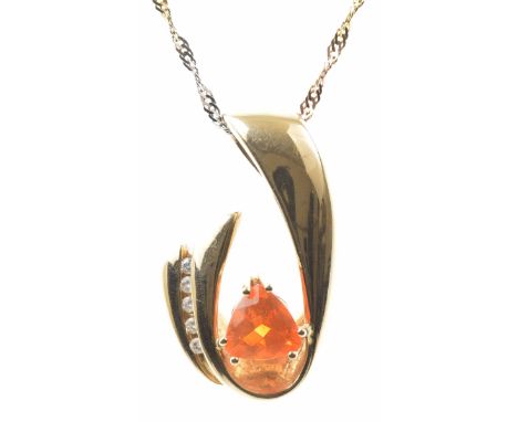 A fire opal and diamond pendantThe triangular shape fire opal to an abstract gold mount, with round brilliant-cut diamond hig