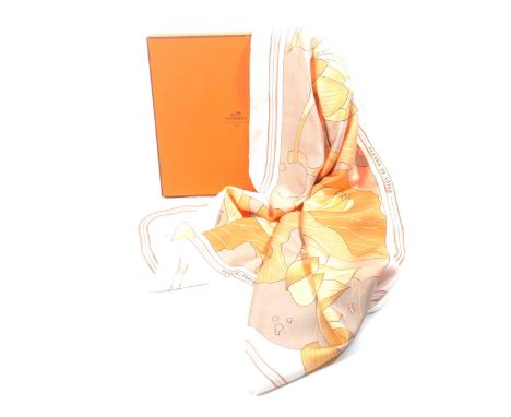 A Hermes 'Fleurs de Lotus' silk scarf The scarf depicting lotus flowers in peach, pink and ochre colours, sold with original 