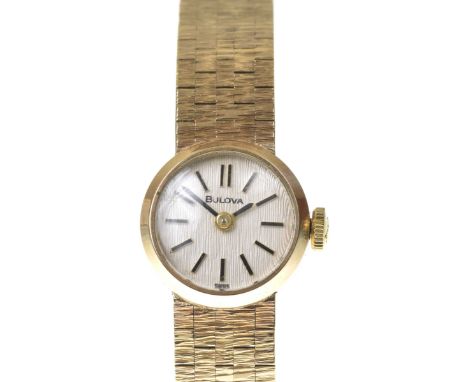 Bulova: A ladies 9k gold manual wind bracelet watchThe white textured dial with applied black hour markers and black hands, f