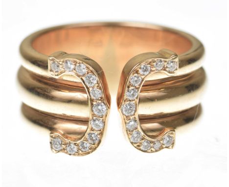 Cartier: A diamond set 'Double C Decor' ringIn 18k rose gold, the 'C's set with round brilliant-cut diamonds, with triple ban