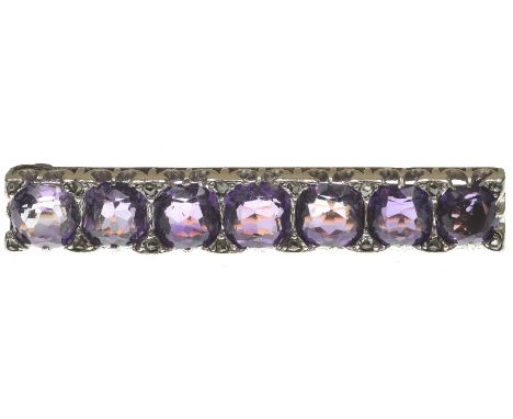 An early 20th century amethyst and diamond bar broochThe uniform row of cushion shape amethysts, with rose-cut diamond highli