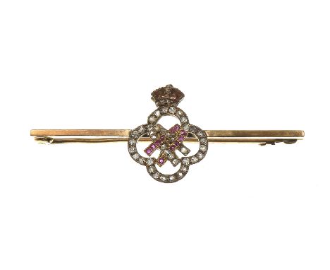 Of Royal interest: A diamond and ruby bar broochThe quatre-foil design set with old-cut diamonds, surmounted by an enamel cor