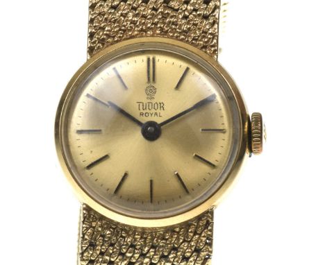 Tudor: A ladies 9k gold manual wind bracelet watchThe gold tone dial with applied black baton hour markers and black hands, f