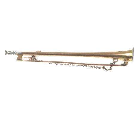 An Edwardian novelty broochModelled as a hunting horn in precious yellow and white metal, with safety chain, length 7.3cm