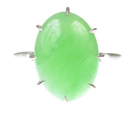 A jade ringThe oval jade cabochon to a precious white metal shank, stamped 18ct, ring size O   CONDITION REPORT:  Weight appr
